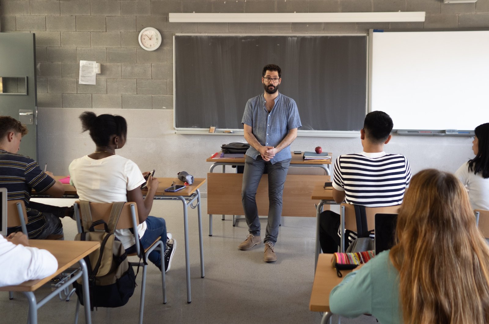 Male teacher explaining the class lesson in a classroom